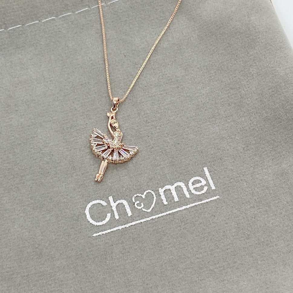 Ballerina cubic zirconia pendant necklace with rosegold plating on gray background