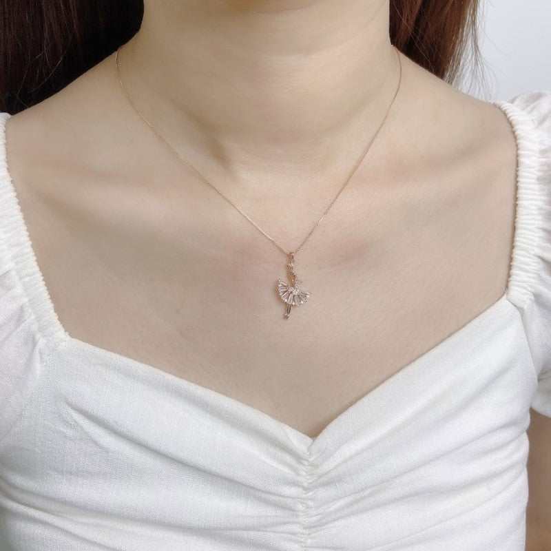 Ballerina cubic zirconia necklace with rosegold plating worn on woman in white top
