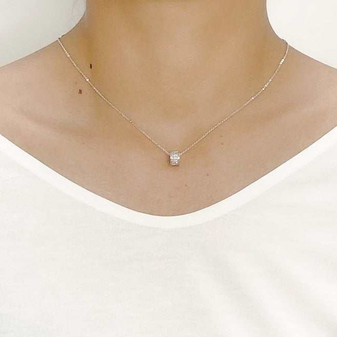 Cubic zirconia tunnel pendant necklace with rhodium plated adjustable chain worn on neck