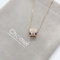 Rose gold tunnel cubic zirconia necklace pendant engraved with "LOVE" on chain with adjustable length