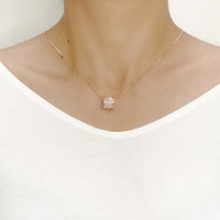 Tunnel cubic zirconia necklace with rosegold plated pendant engraved LOVE worn on neck