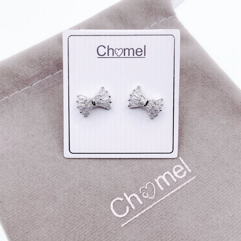 Ribbon cubic zirconia stud earrings with rhodium plated finish on branded card