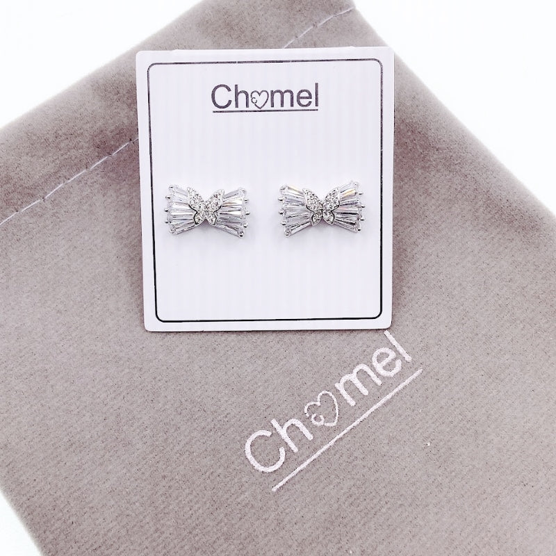 Ribbon cubic zirconia stud earrings with butterfly center on rhodium plated post backing displayed on branded card and fabric pouch