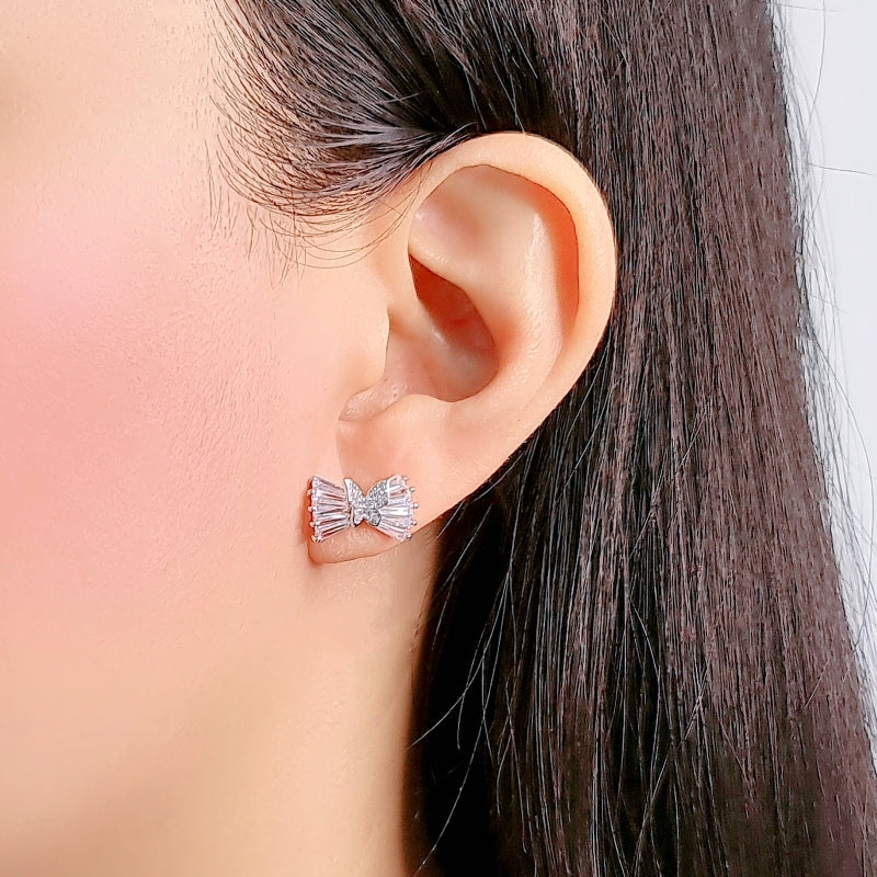 Ribbon cubic zirconia stud earring shaped like a ribbon with butterfly detail on ear