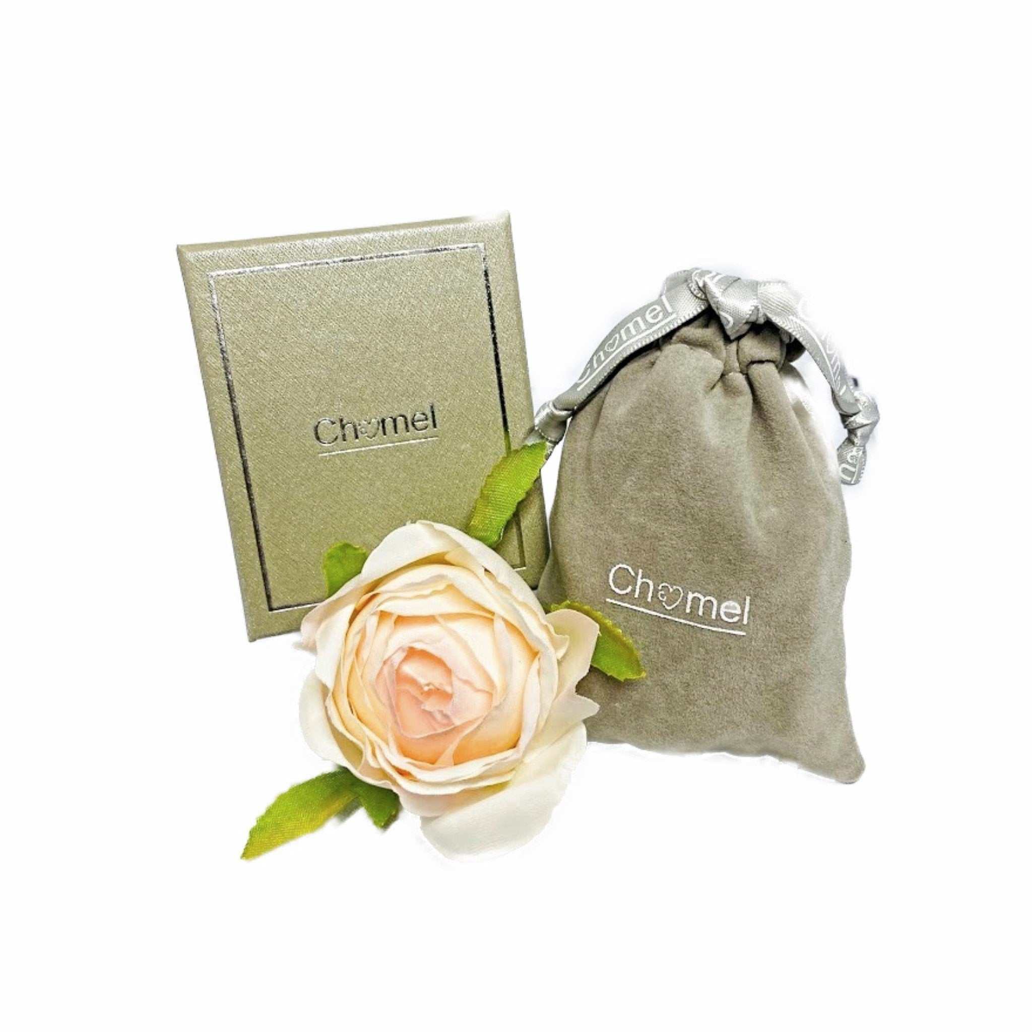 Freshwater pearl button stud earrings in rhodium plated finish with packaging and a cream rose